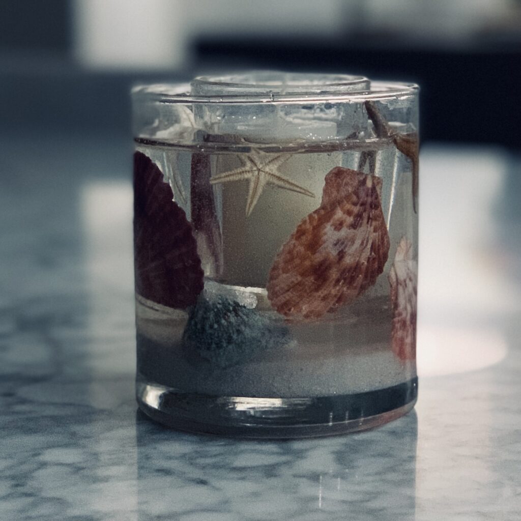 Such a cool gift! It's a votive candle holder with the actual seashells that were on Steve's and my wedding cake!